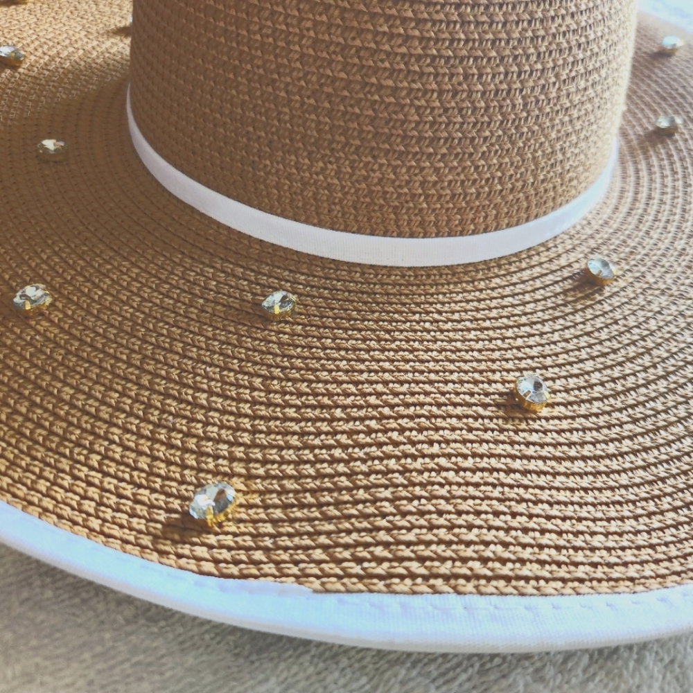 Woman's white trimmed faux diamond studded hat.